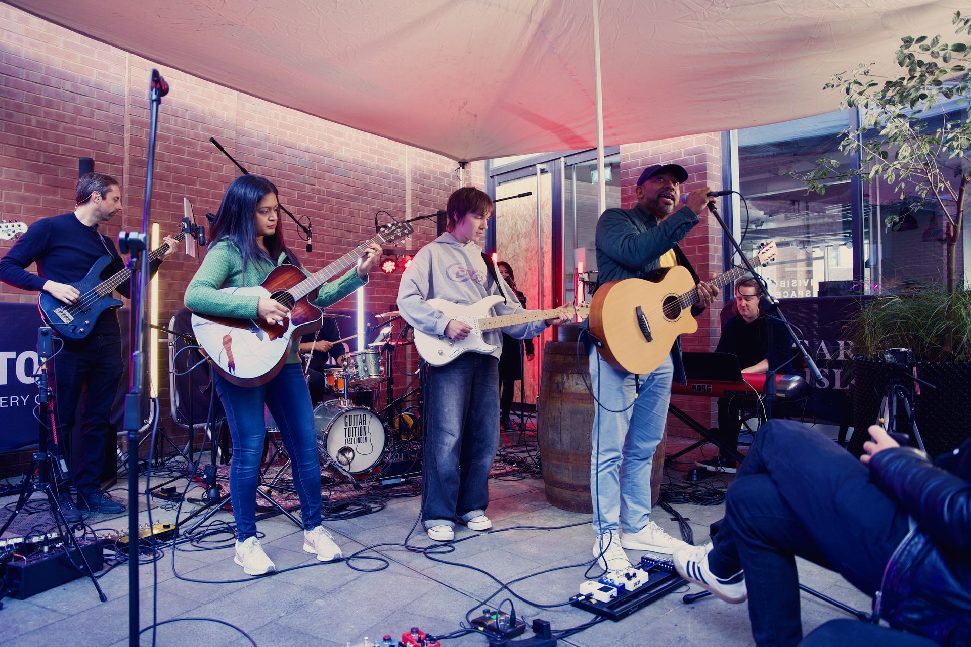 A group of people are playing guitars on a stage.