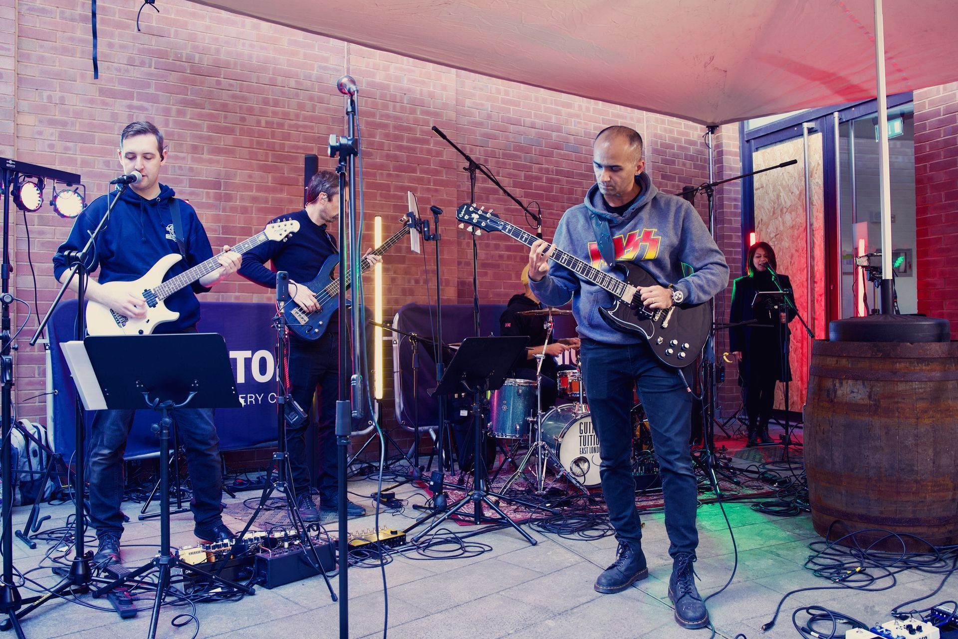 A group of men are playing guitars and singing into microphones on a stage.