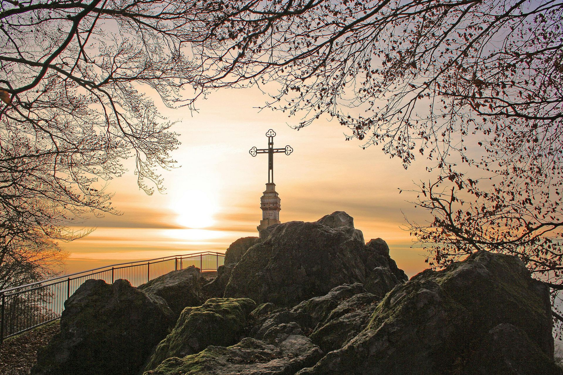 A cross on a hill during sunrise to signify a new year