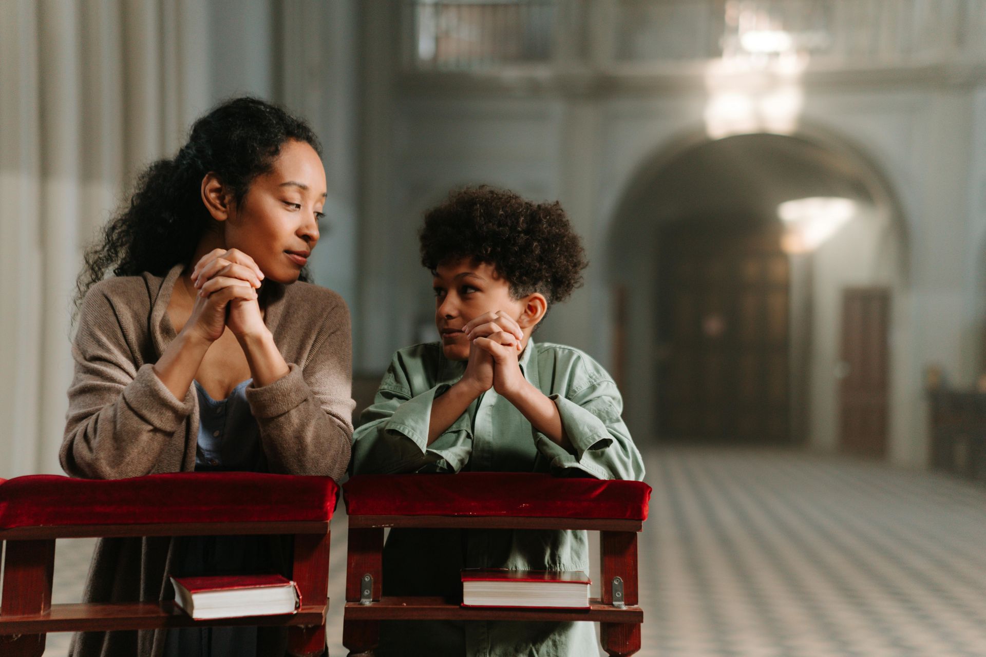 A mother and child praying in church