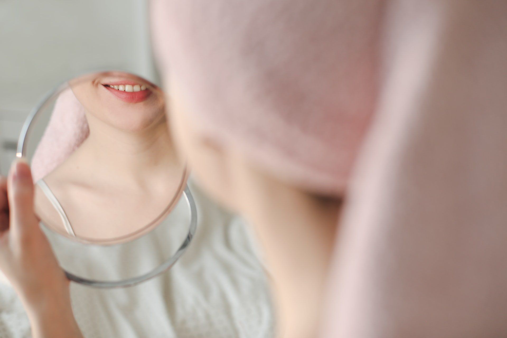 Woman looking in the a small mirror
