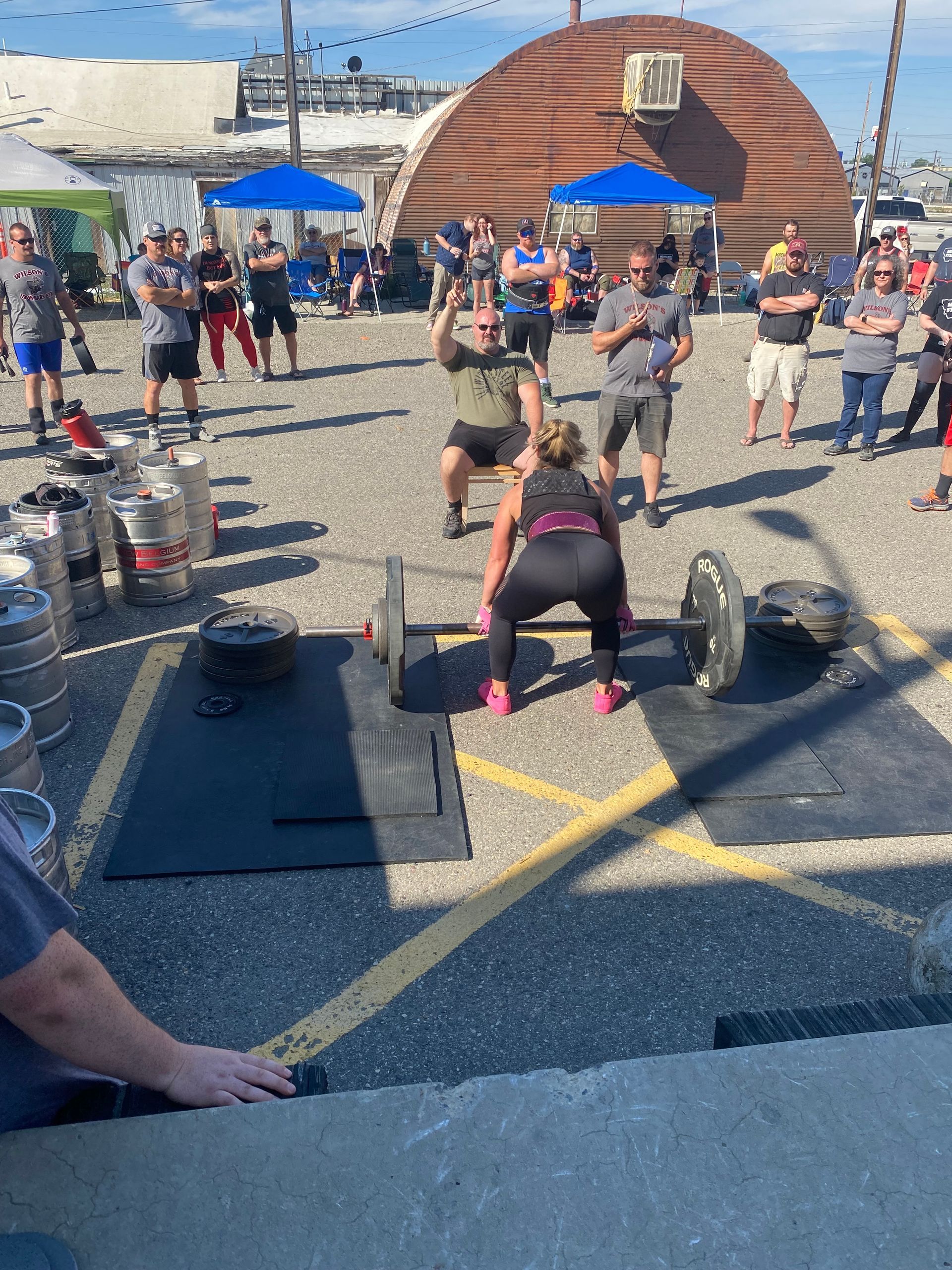 People lifting weights outdoors at an event