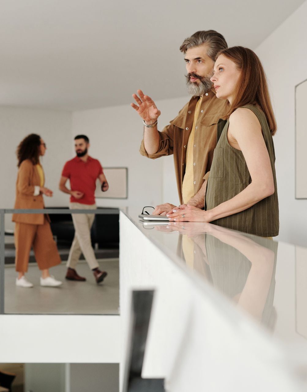 A man and a woman are standing next to each other in a room.