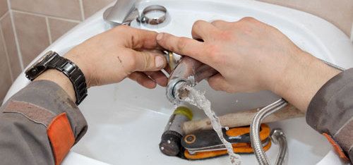 Professional providing plumbing service in bathroom basin in New Plymouth, NZ