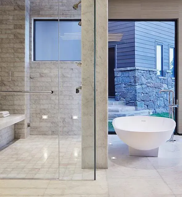 A bathroom with a tub and a walk in shower