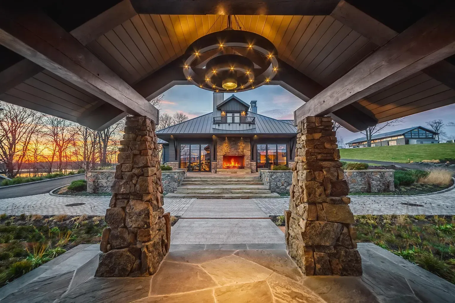 A large house with a stone walkway leading to it.