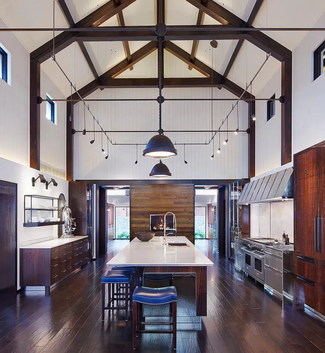A kitchen with a vaulted ceiling and a large island