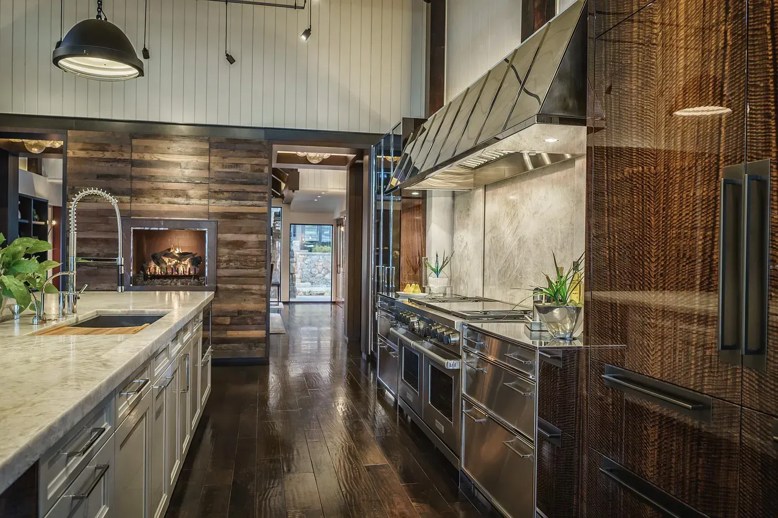 A kitchen with stainless steel appliances and wooden cabinets