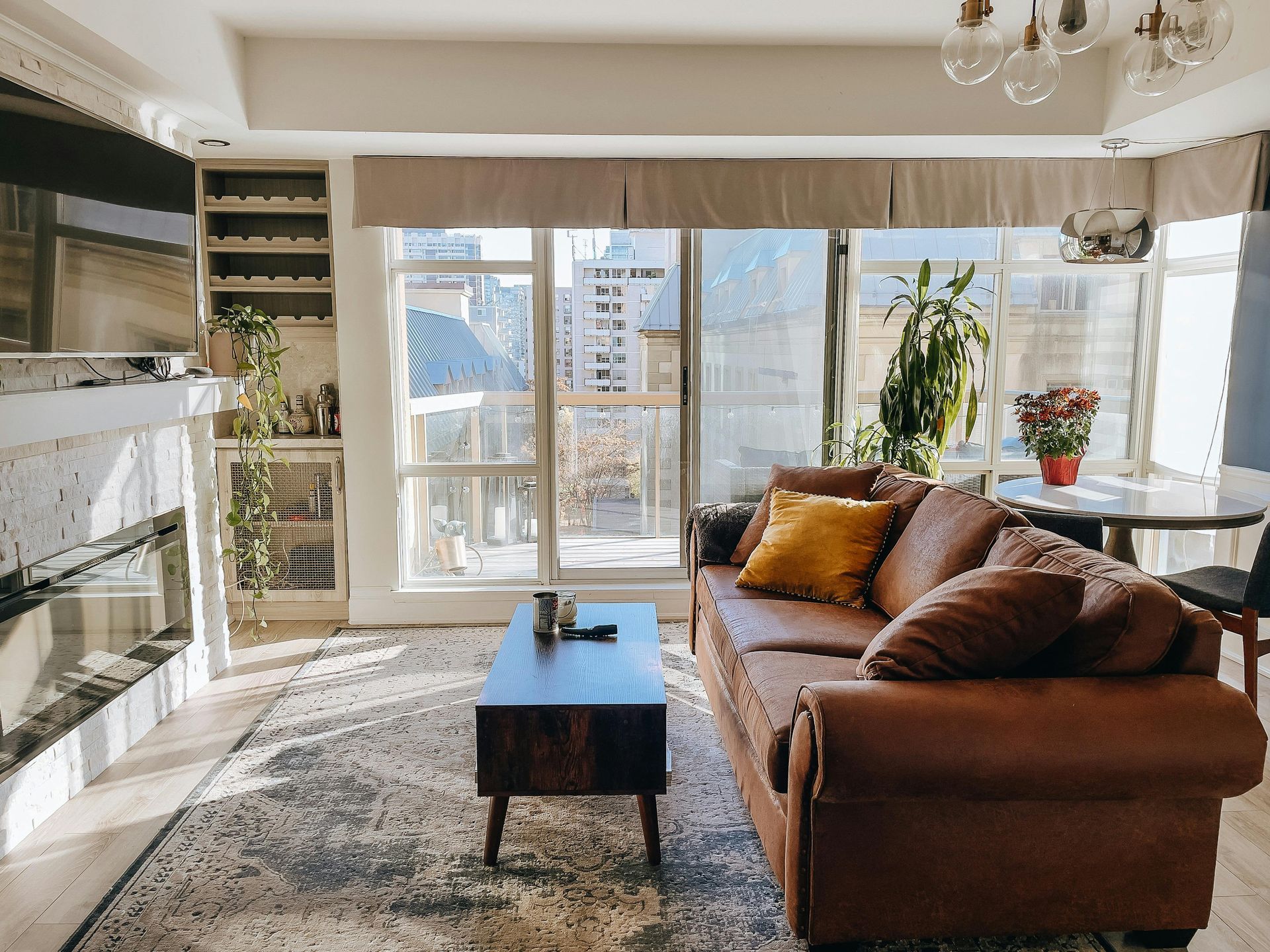 A living room with a brown couch and a coffee table.