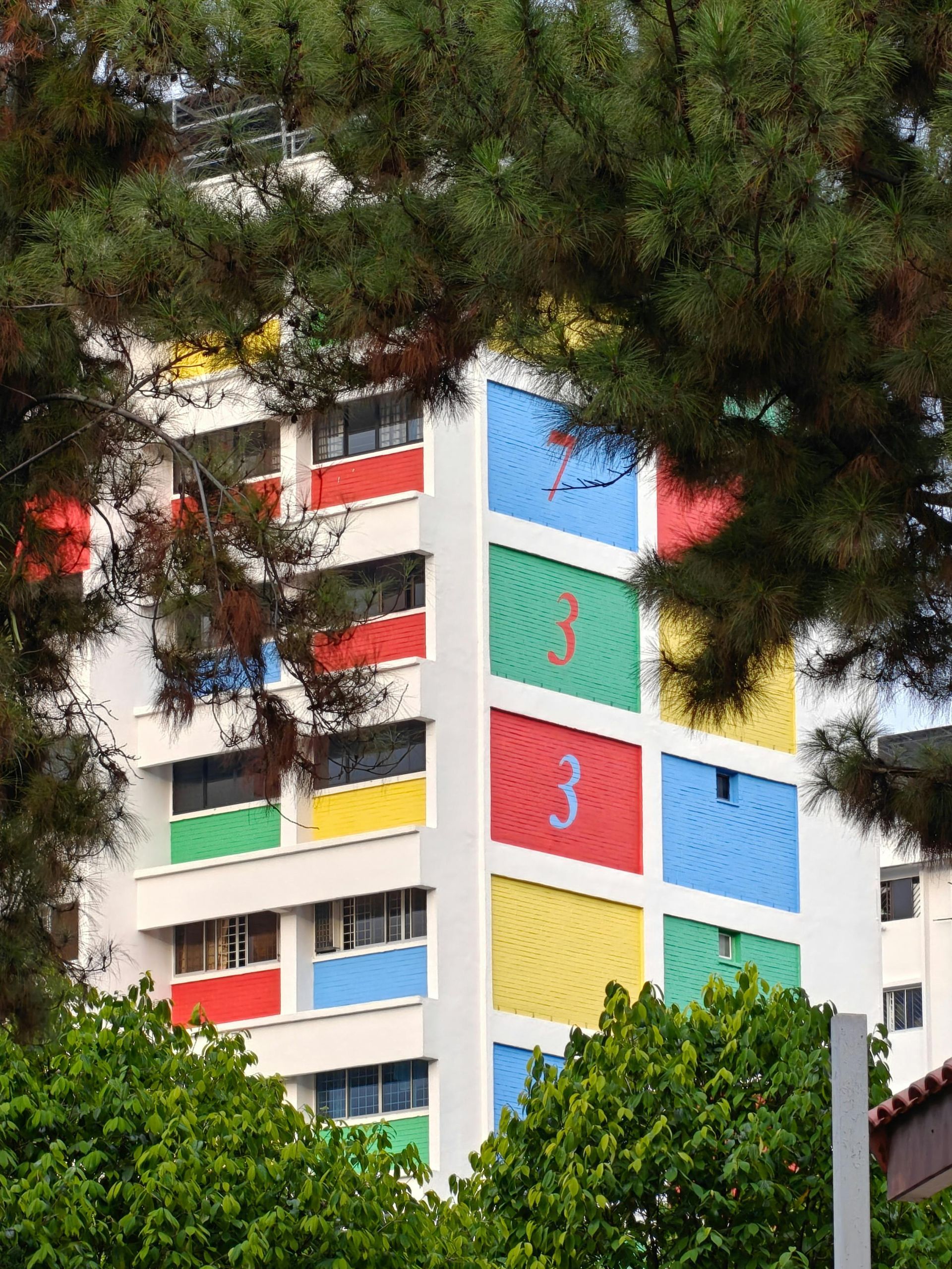 A colorful building with the numbers 3 and 3 on the side