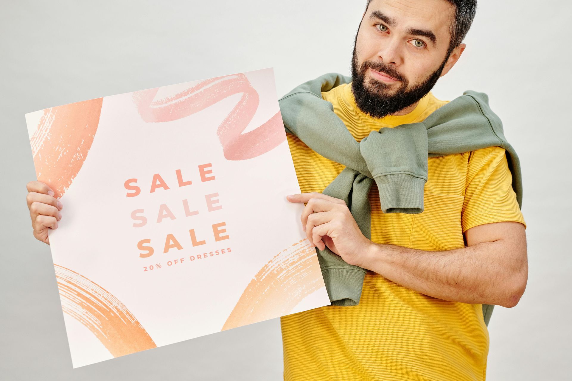 A man is holding a sign that says `` sale sale sale ''.