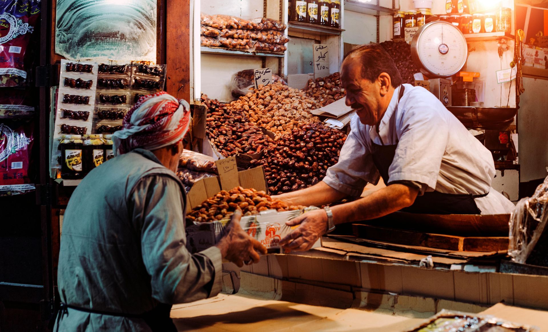 A man is selling nuts to a woman in a store