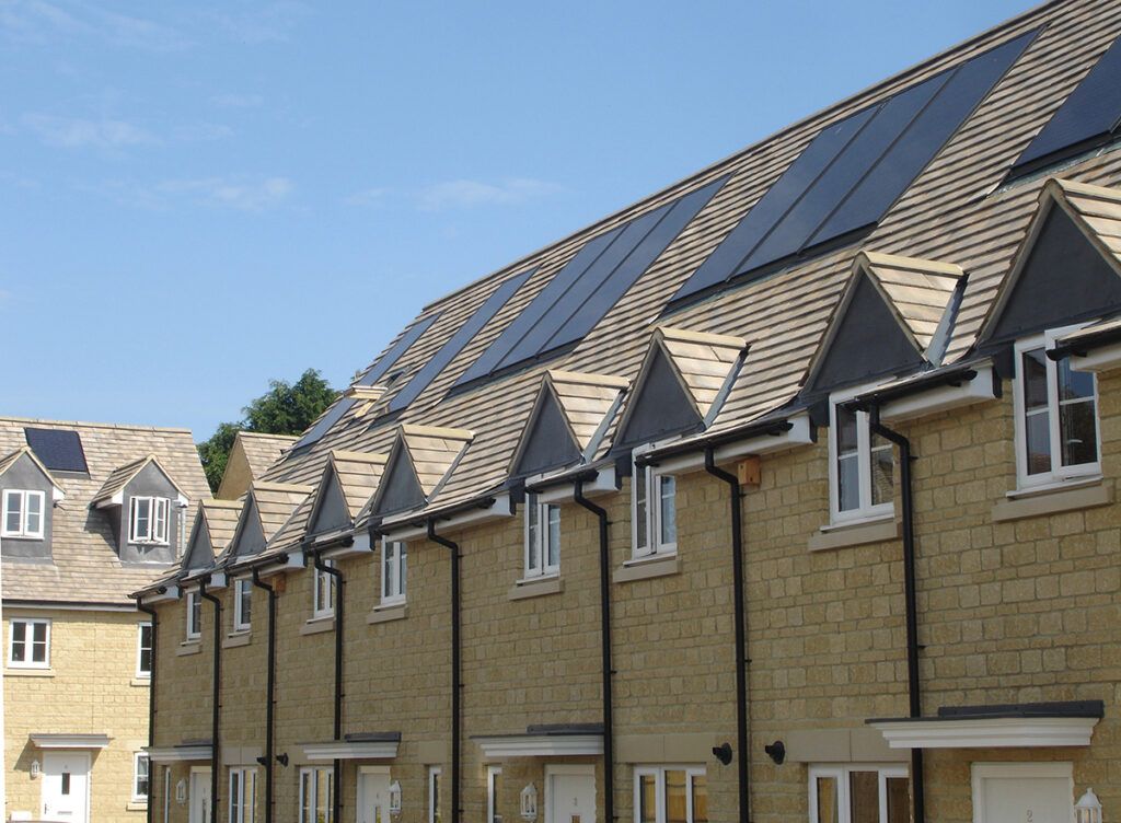 A row of houses with solar panels on the roofs