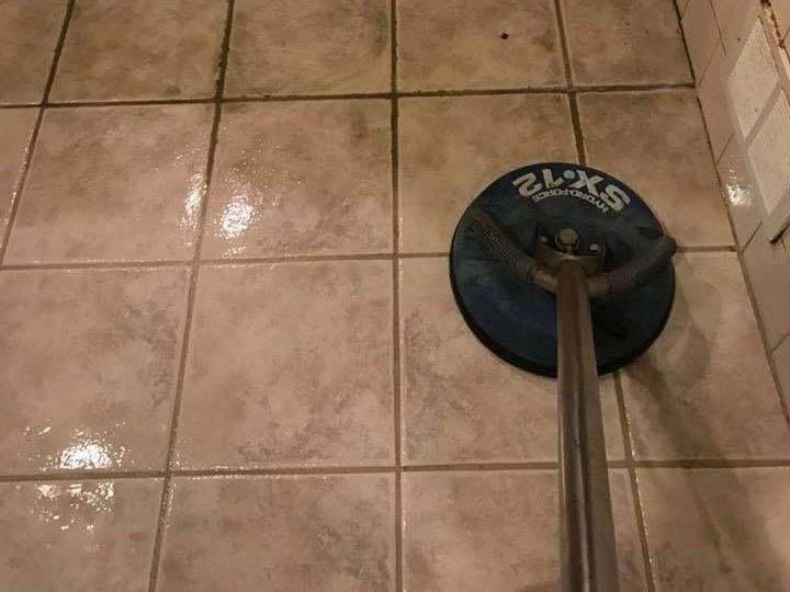 A tile floor with a cleaner on it.