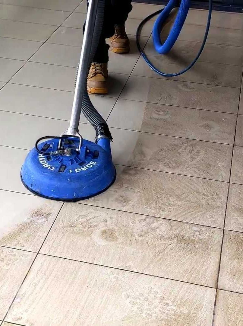 ands-wearing-yellow-rubber-gloves-are-using-plastic-floor-scrubber-scrub-tile-floor-with-floor-cleaner-