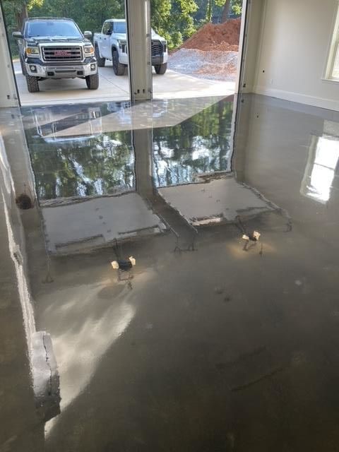 A gmc truck is parked in a garage with a shiny floor.