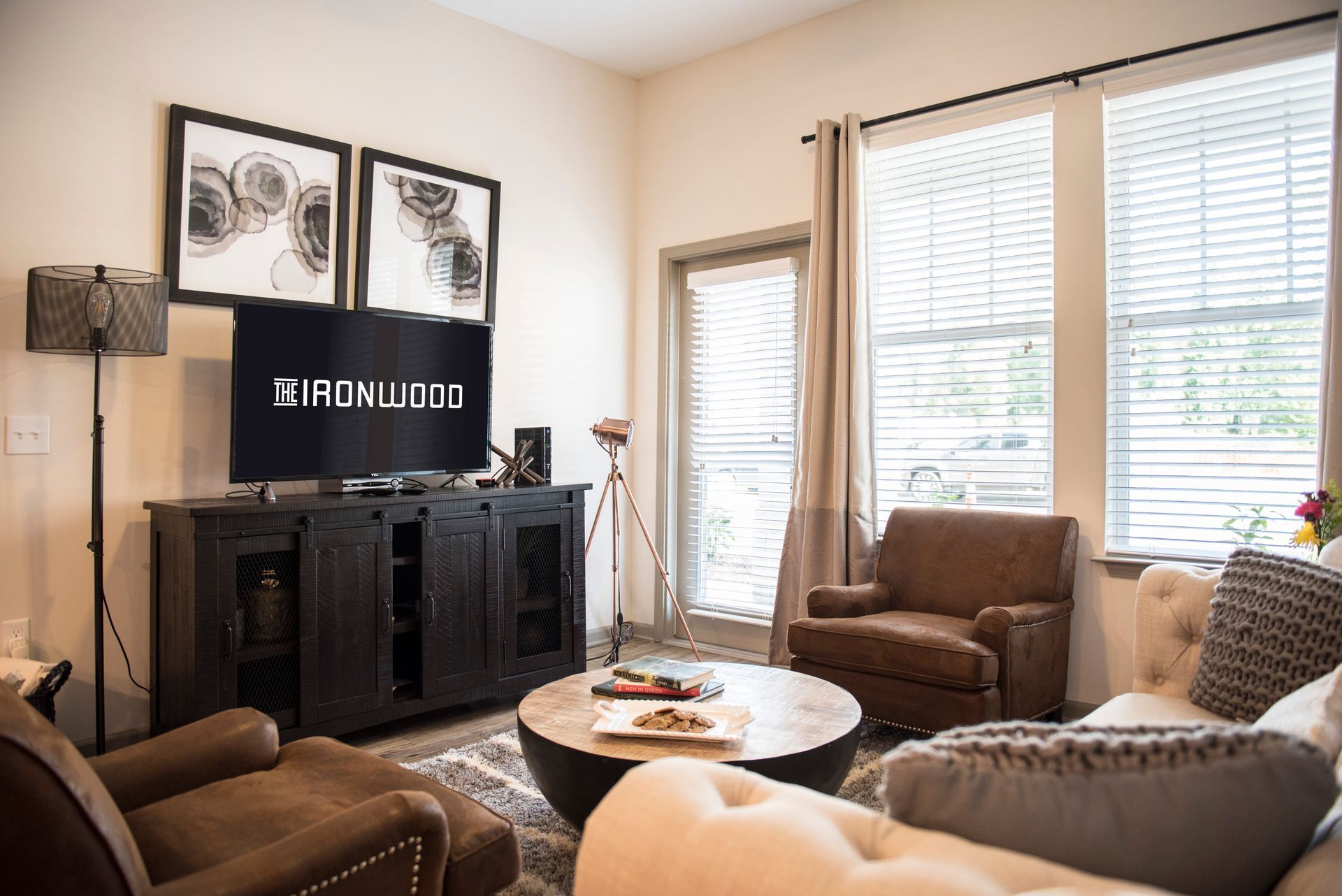 Living room with TV, seating, and a window.