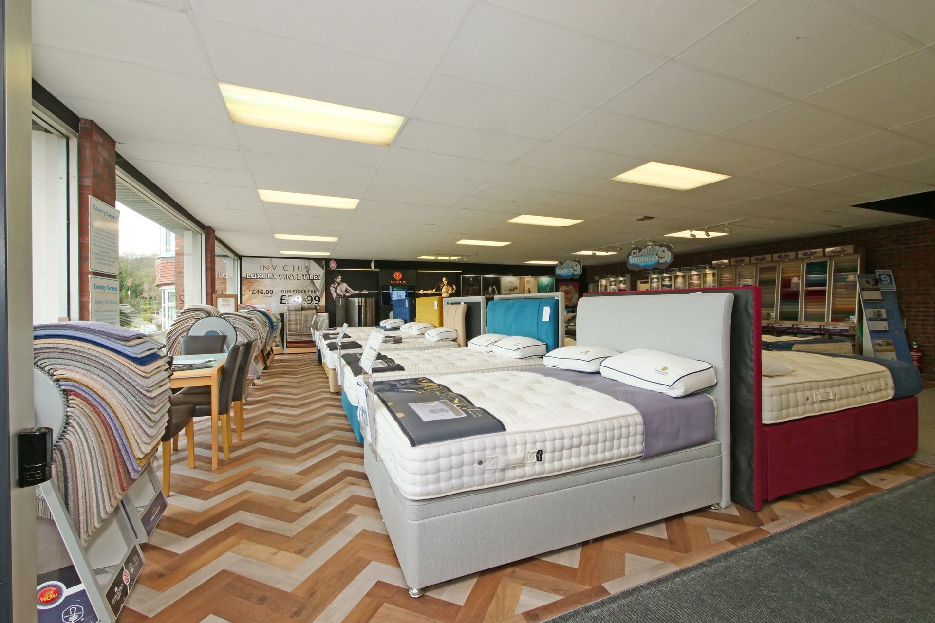 A large room filled with lots of beds and chairs.