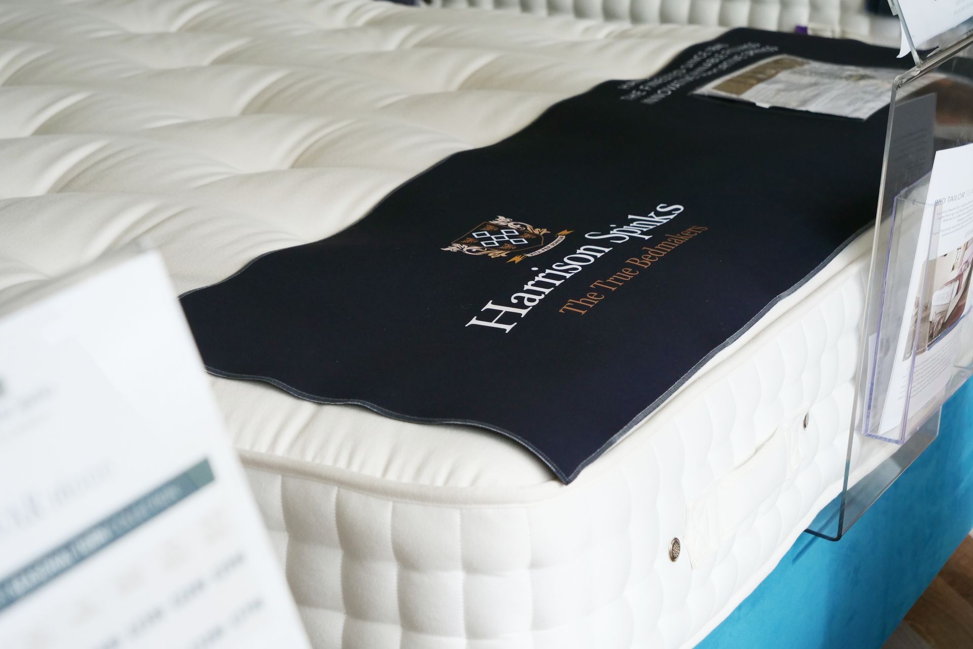 A mattress with a blanket on top of it that says harvest beds