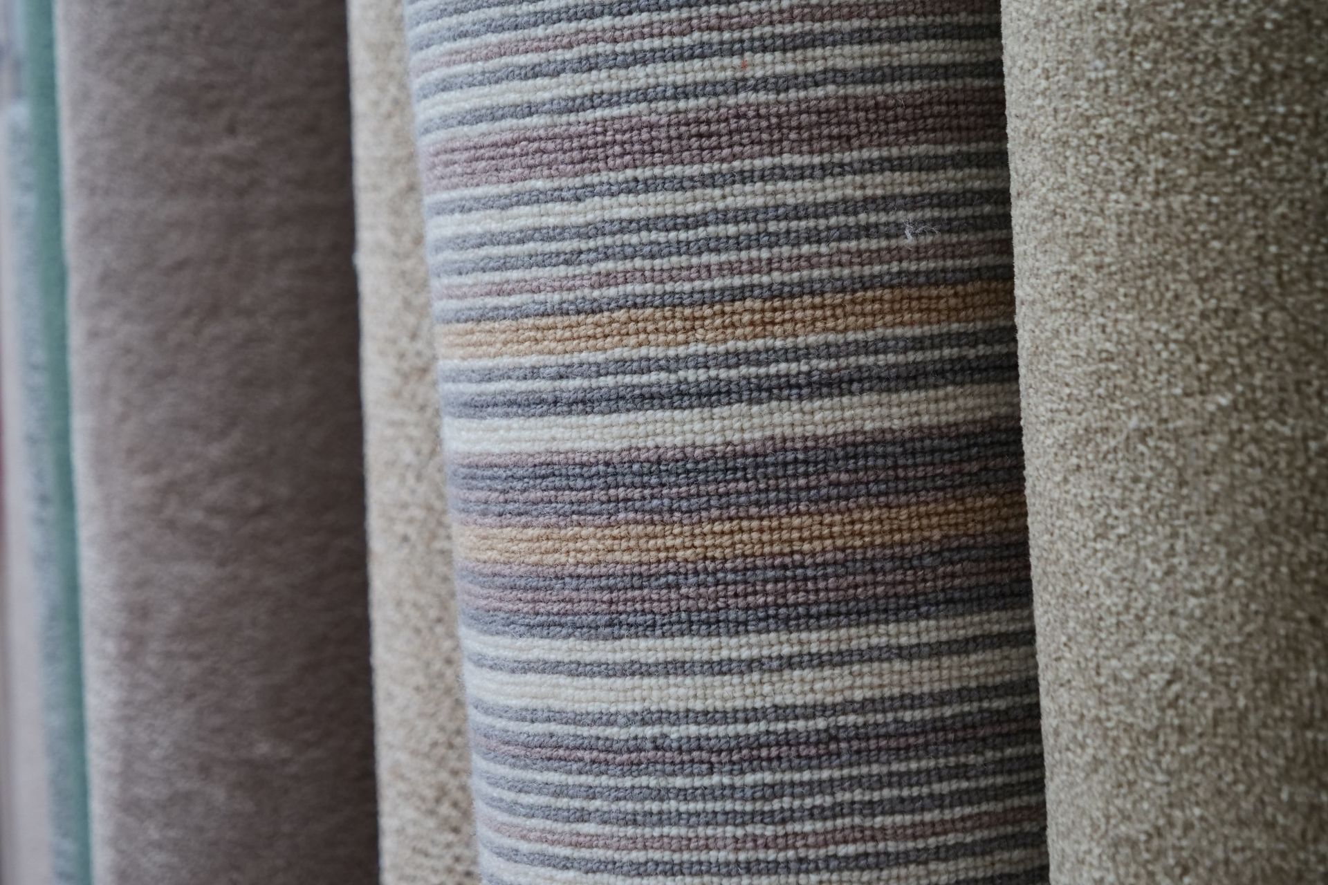 A close up of a striped carpet in a store.