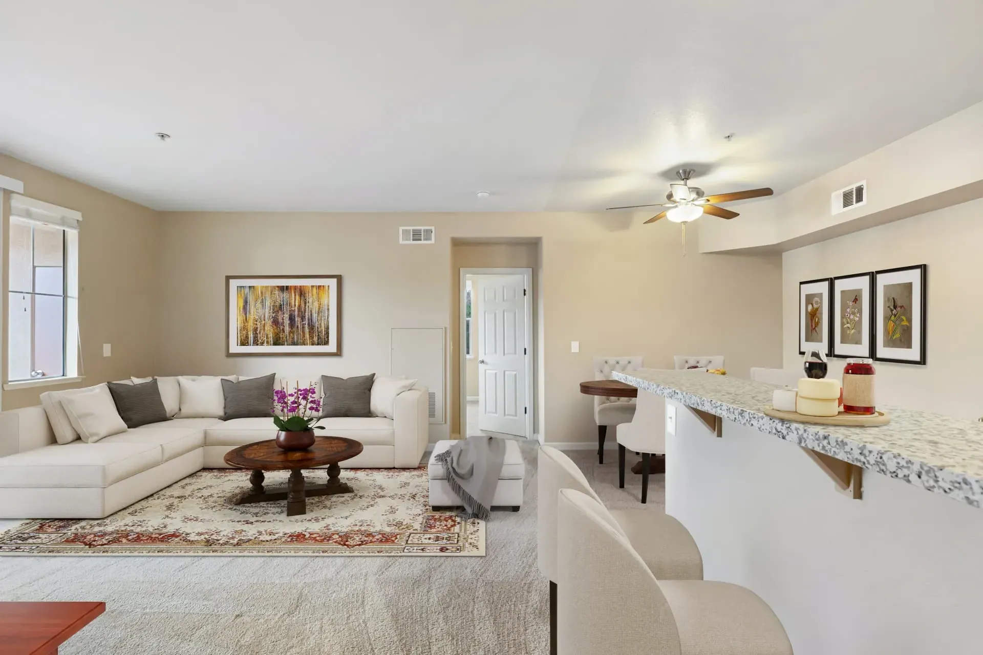 Spacious living room with a sectional sofa, coffee table, and dining area.