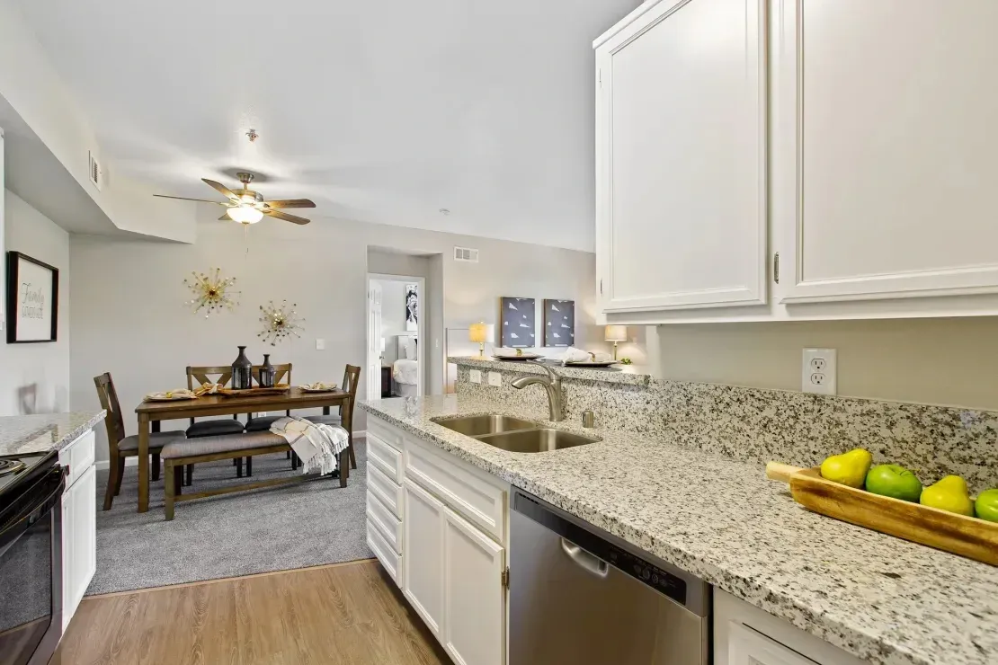 Modern kitchen with granite countertops and stainless steel appliances.