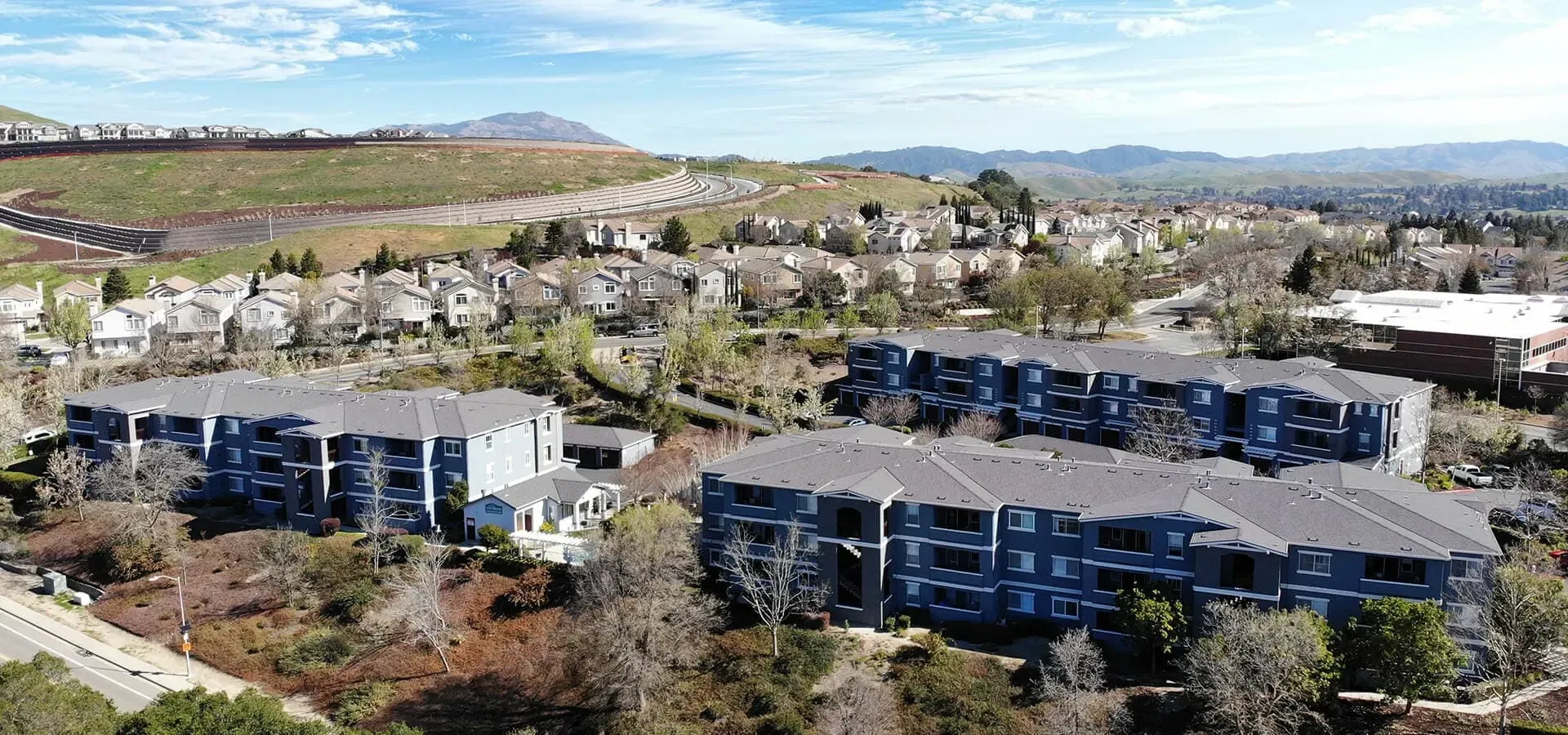 Aerial view of apartment buildings and surrounding neighborhood.
