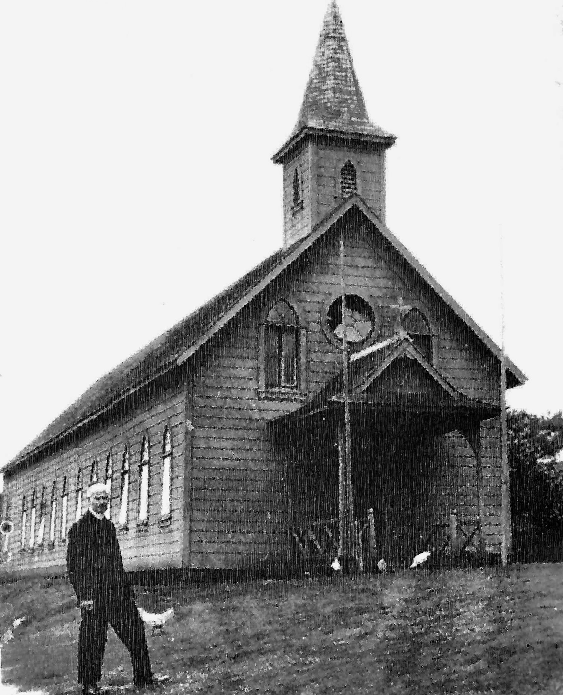 Black and white photo of st. Catherine church, larger and with a veranda on the front 