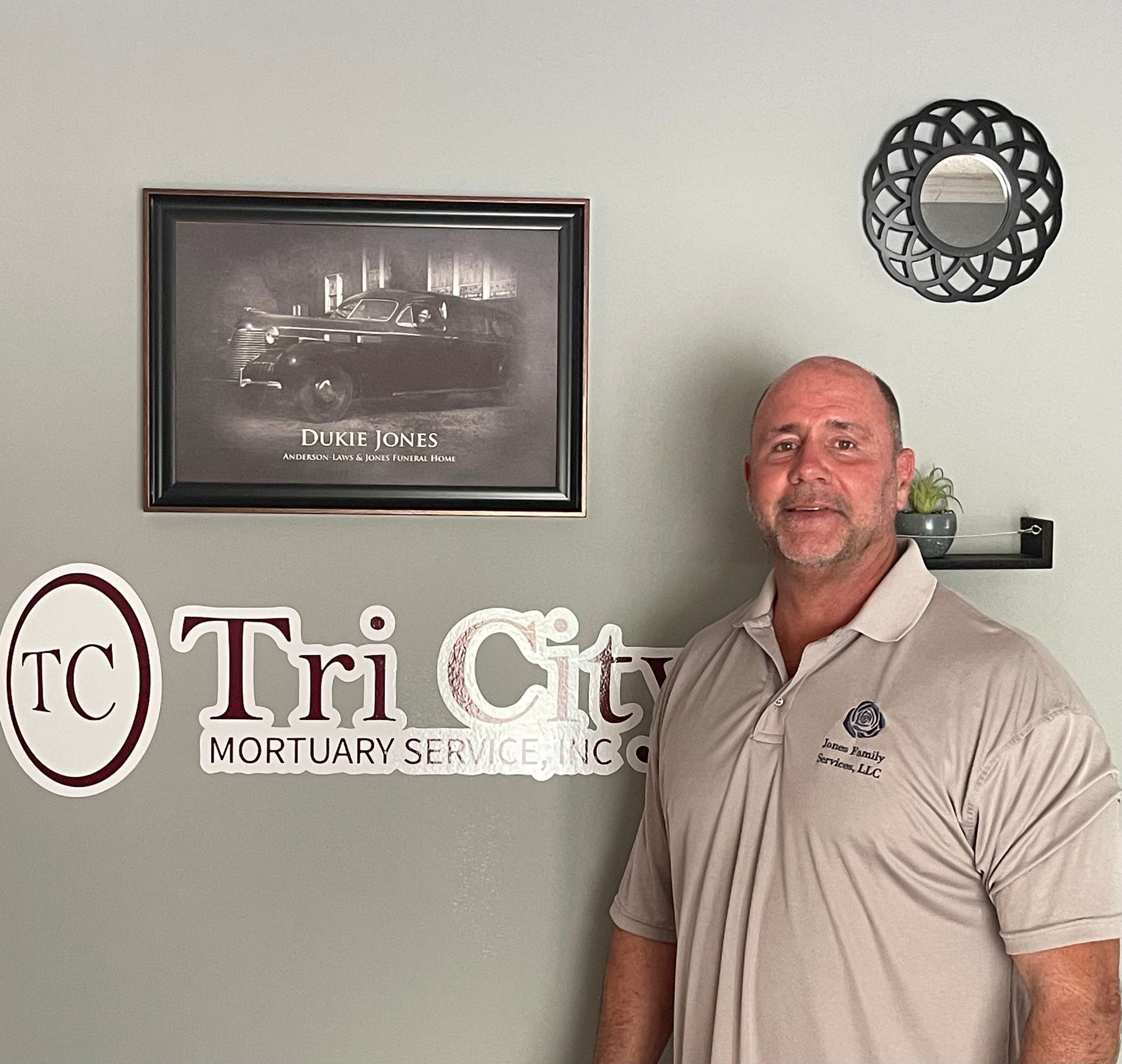 Jeff Jones in a suit and tie is smiling for the camera