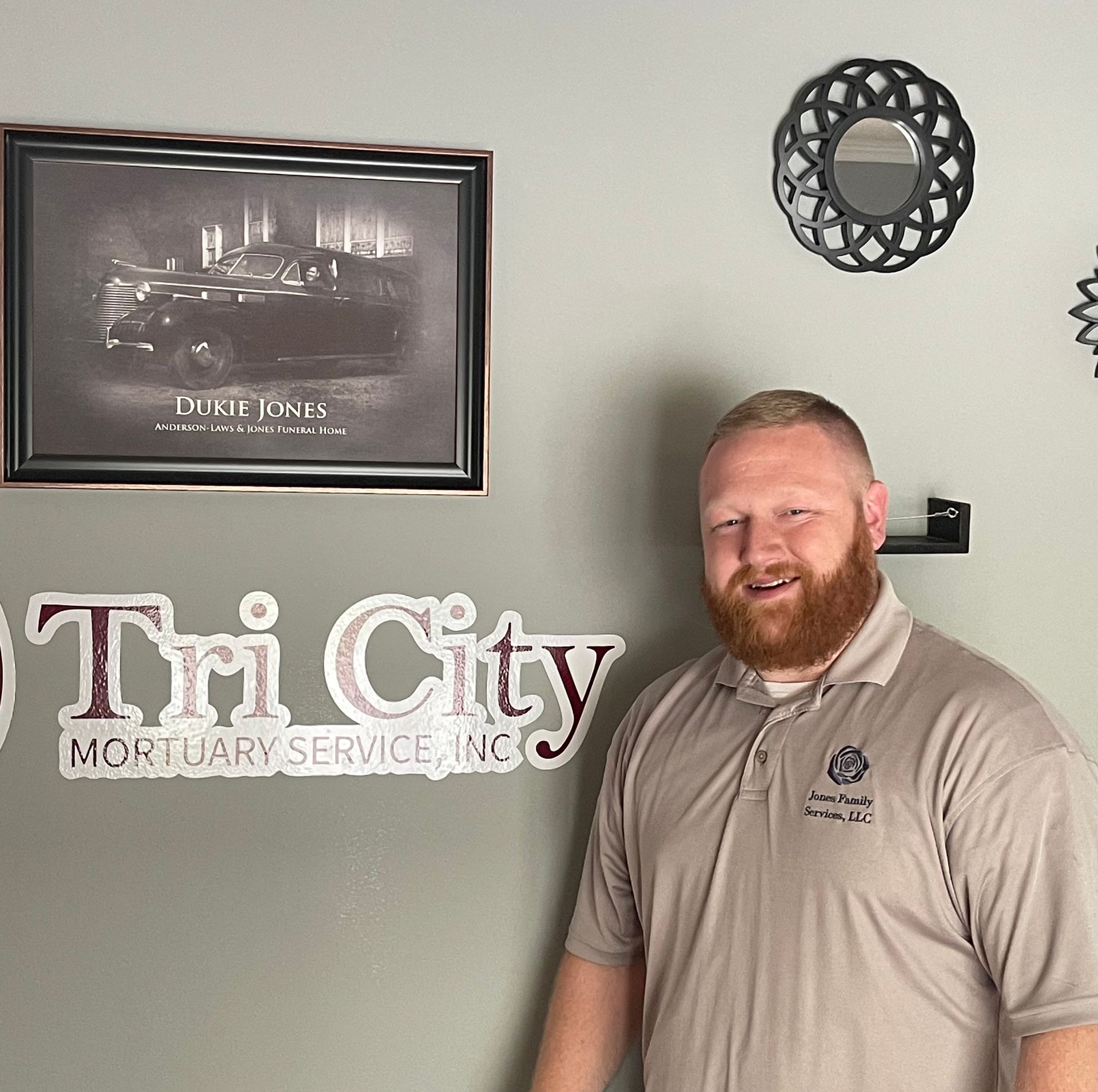 Jessee Hagan in a suit and tie is smiling for the camera.