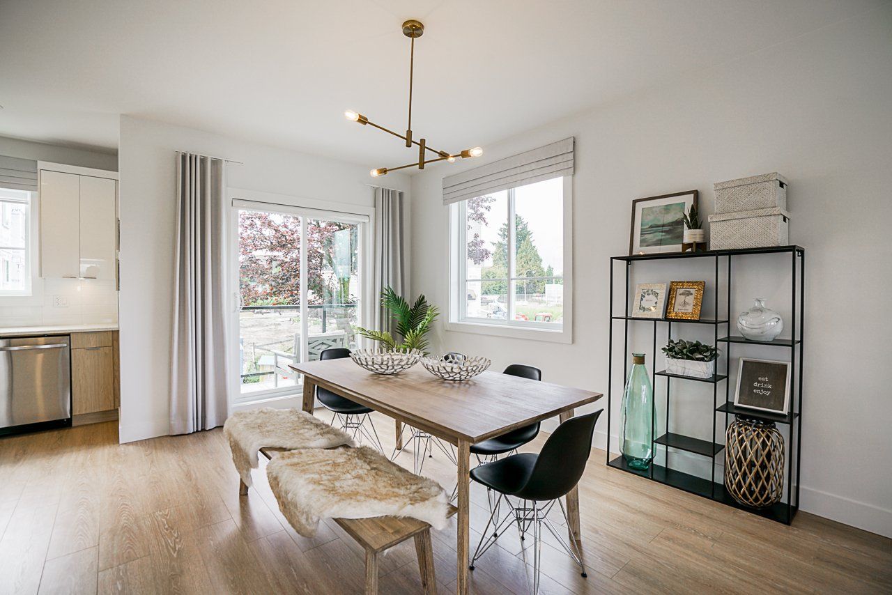 A dining room with a wooden table, a bench with a fur throw, and a black chair, next to a sliding door and shelves.