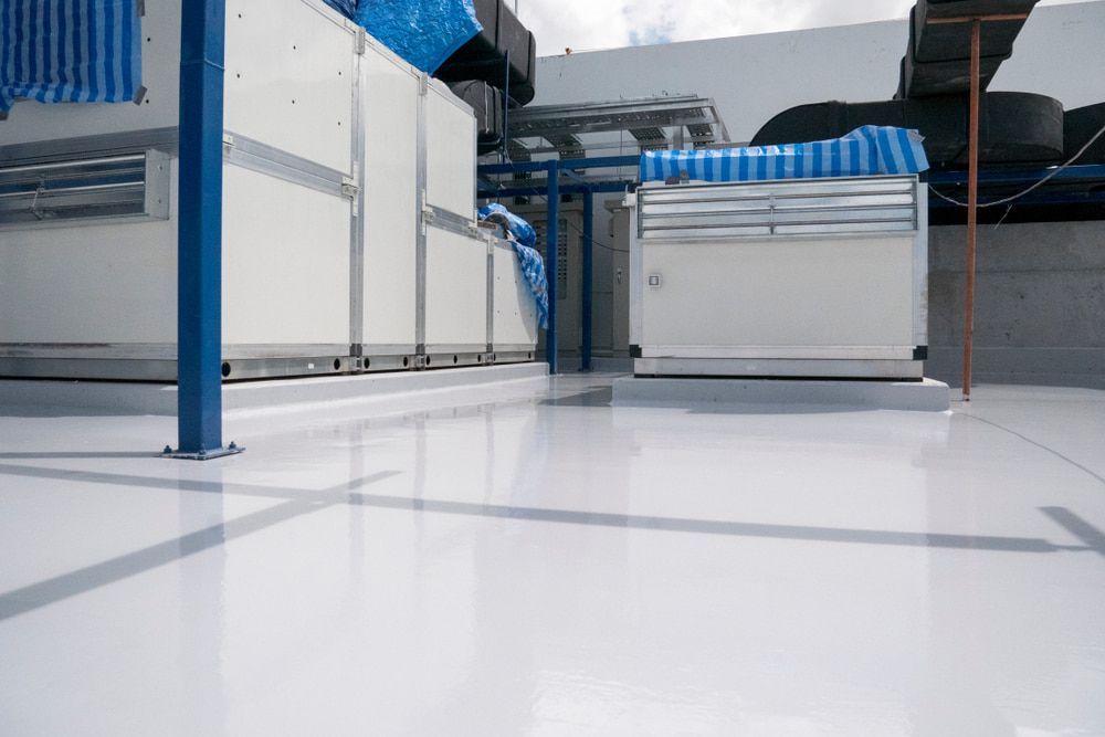 A White Floor with A Blue Pole in The Background — Fraser Coast Waterproofing in Craignish, QLD
