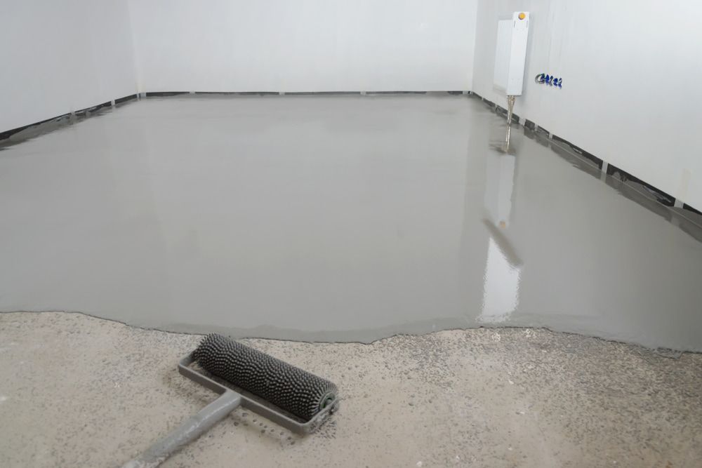 A Roller Is Sitting on The Floor of A Room — Fraser Coast Waterproofing in Torquay, QLD