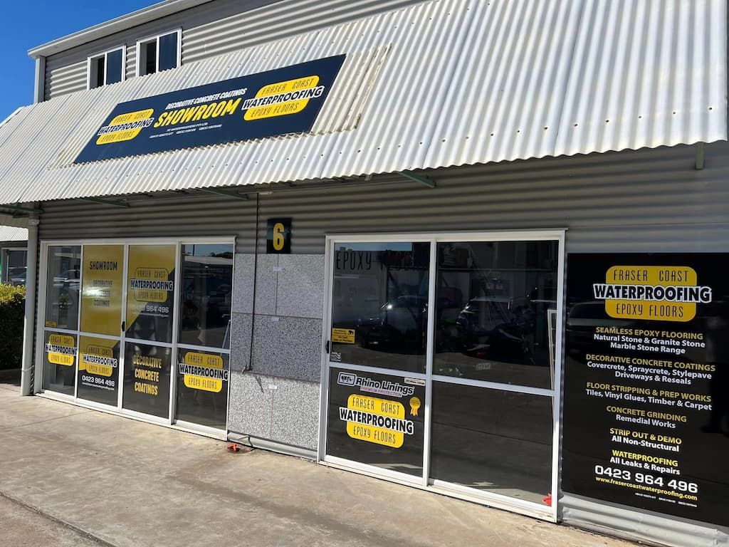 The Front of a Building With a Lot of Windows and a Sign — Fraser Coast Waterproofing in Pialba, QLD