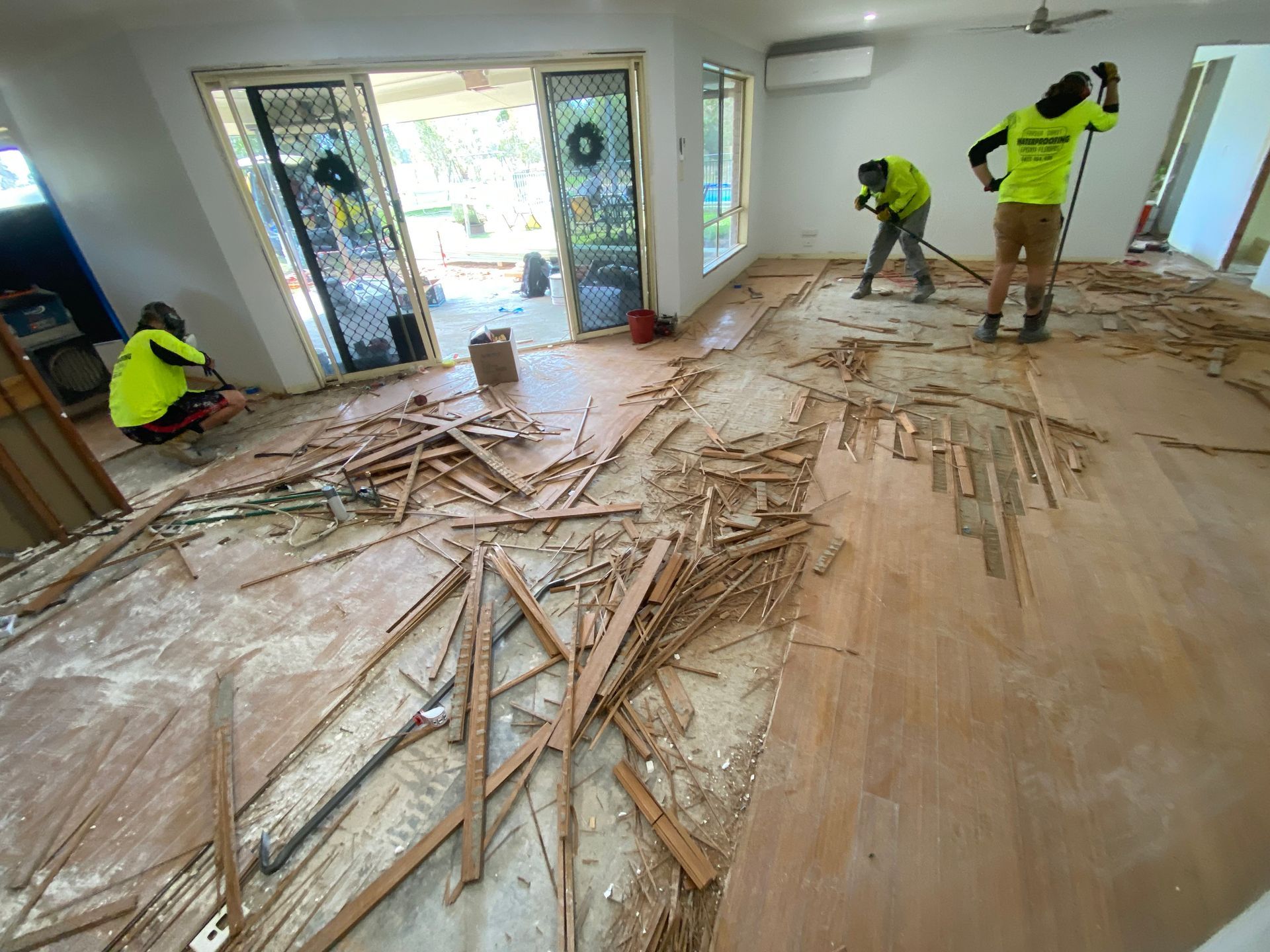 A White Patio with A Wooden Railing and A Fence in Front of A House 
— Fraser Coast Waterproofing in Pialba, QLD
