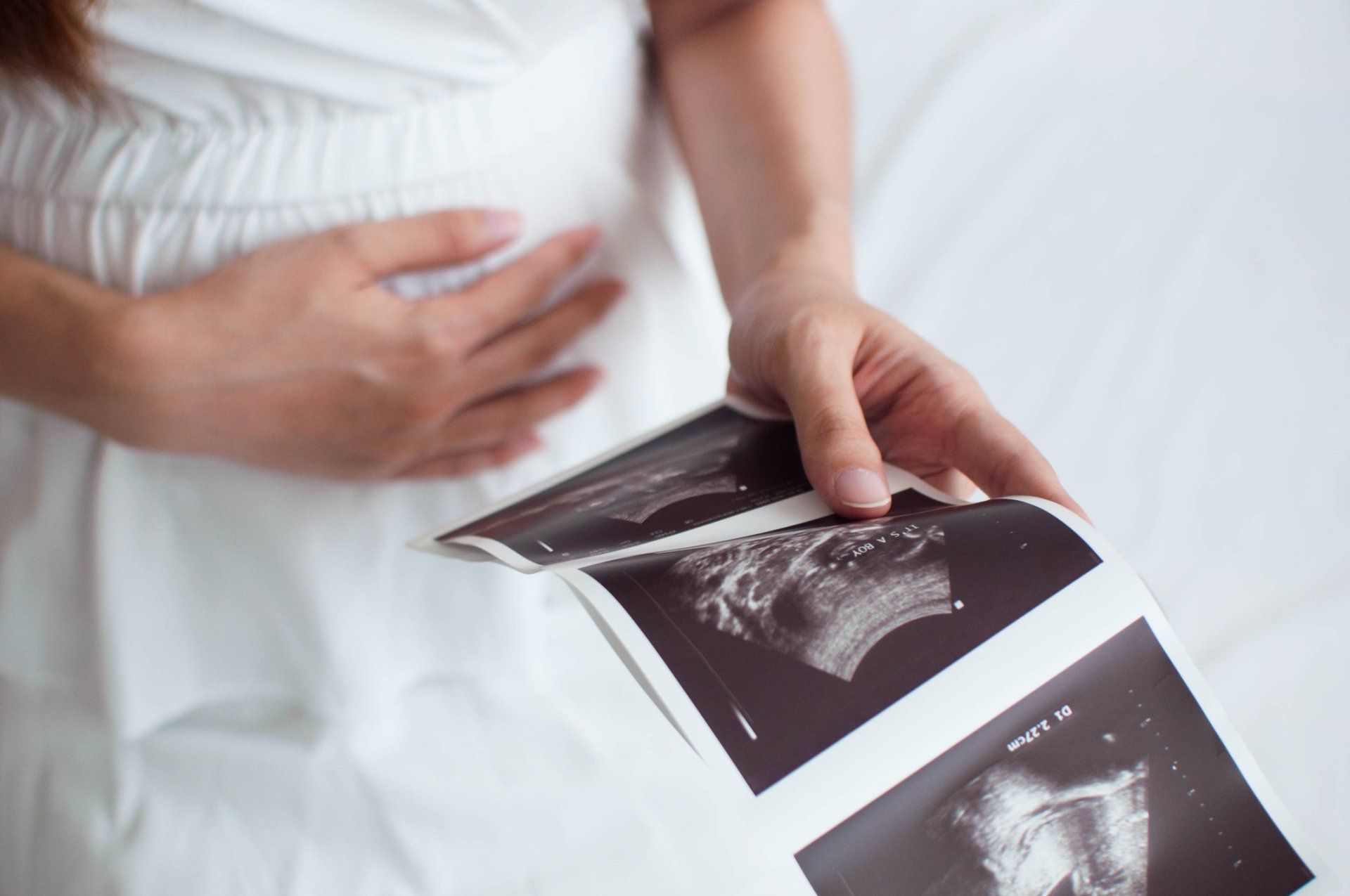 Pregnant Woman Holding Ultrasound Scan Result — Hobart, TAS — Hobart Modern Hypnosis