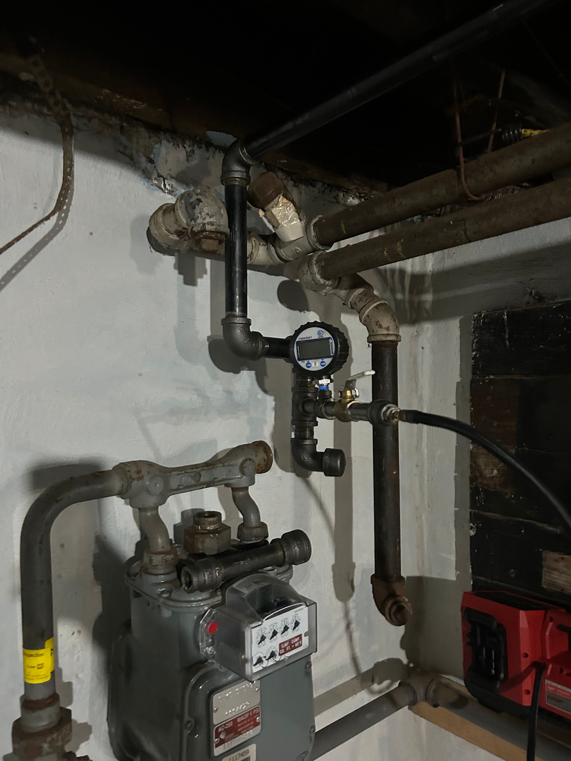 A gas meter with a gauge attached to it