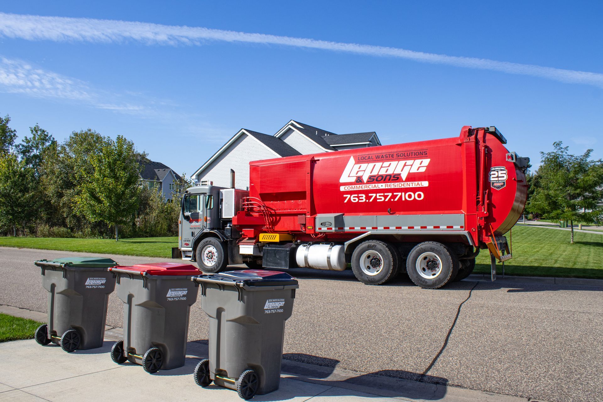 A pickup truck from LePage & Sons, a local waste company, stops in a neighborhood.