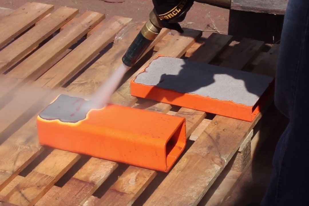 A person is using a dewalt tool to paint a piece of wood