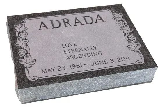 Gray gravestone engraved “ADRADA” with floral border and dates May 23, 1961–June 8, 2011