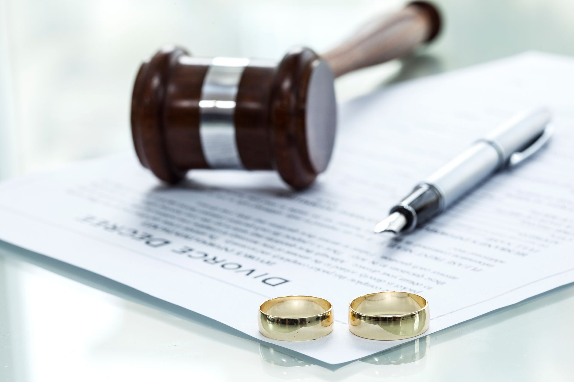 Gavel, rings, and divorce papers symbolizing legal separation and divorce law.