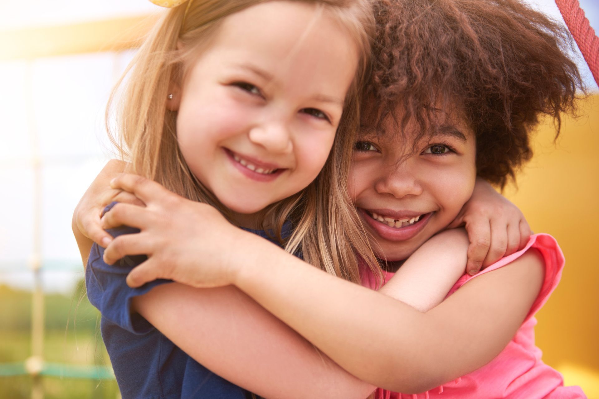 Two Young Girls Hugging Each Other | Jacksonville, AR | Knollmeyer Law Office