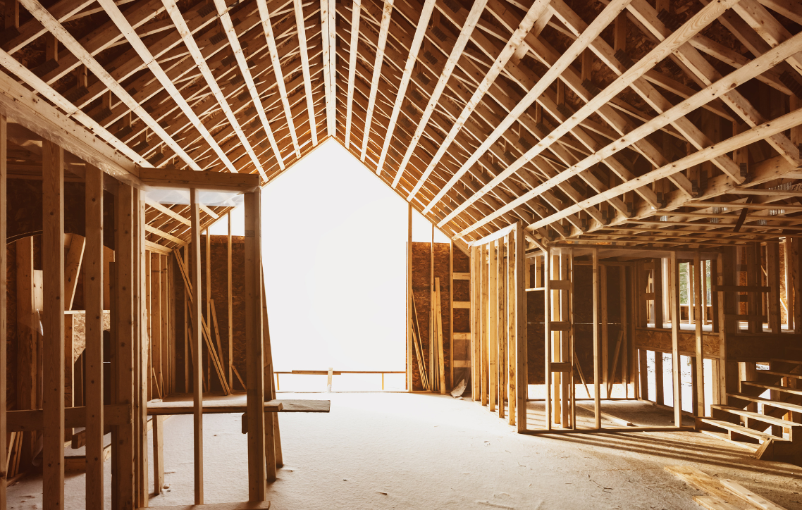 The inside of a building under construction with a large window.