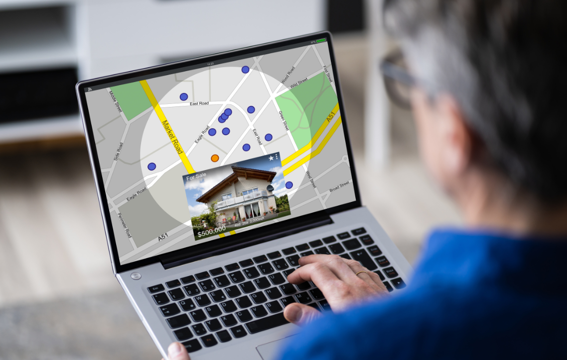 A man is looking at a map on a laptop computer.