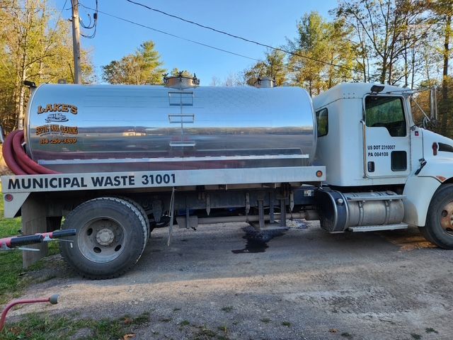 A silver septic truck labeled Municipal Waste parked outside.
