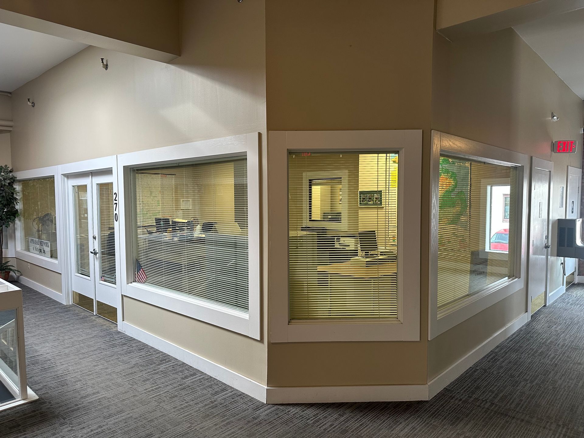 A hallway with a lot of windows and doors