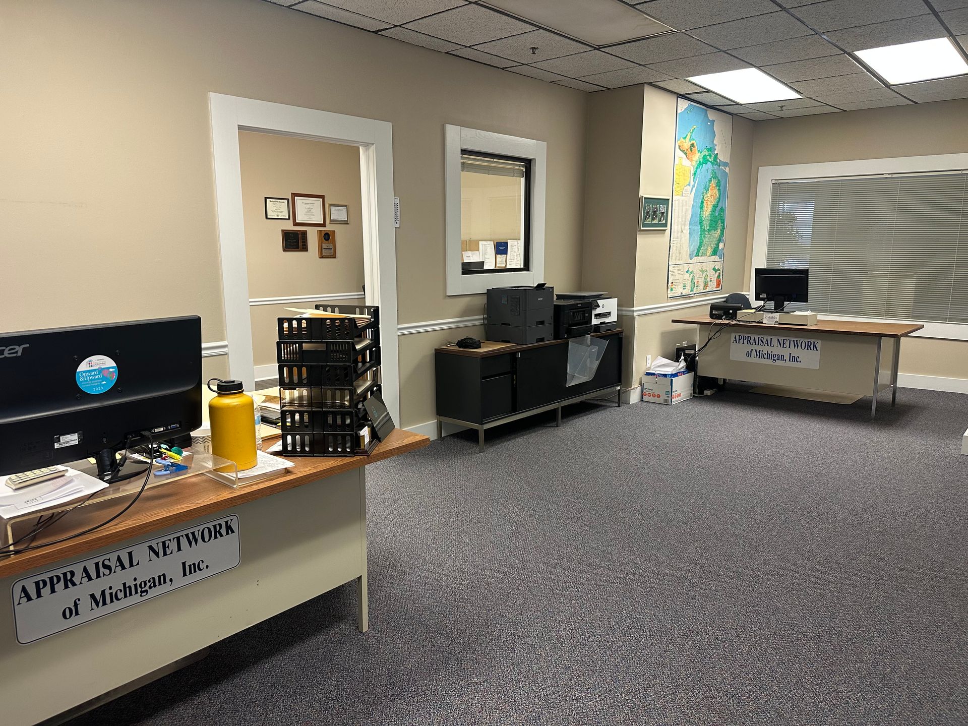 A large room with a lot of desks and computers in it.