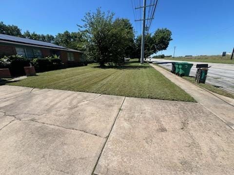 A sidewalk leading to a house with a lush green lawn.