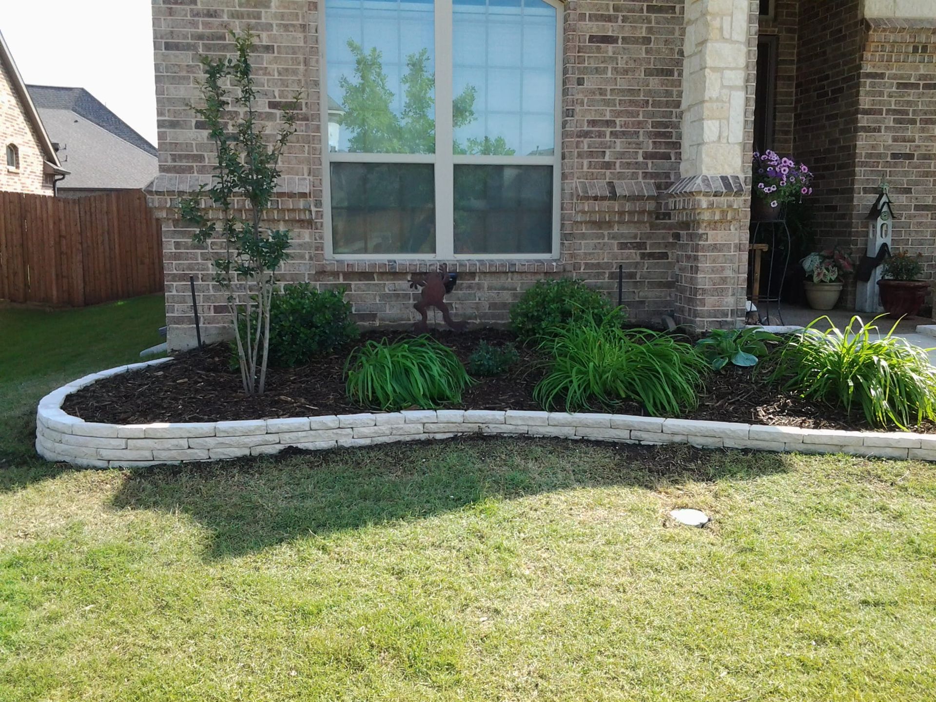 A brick house with a garden in front of it