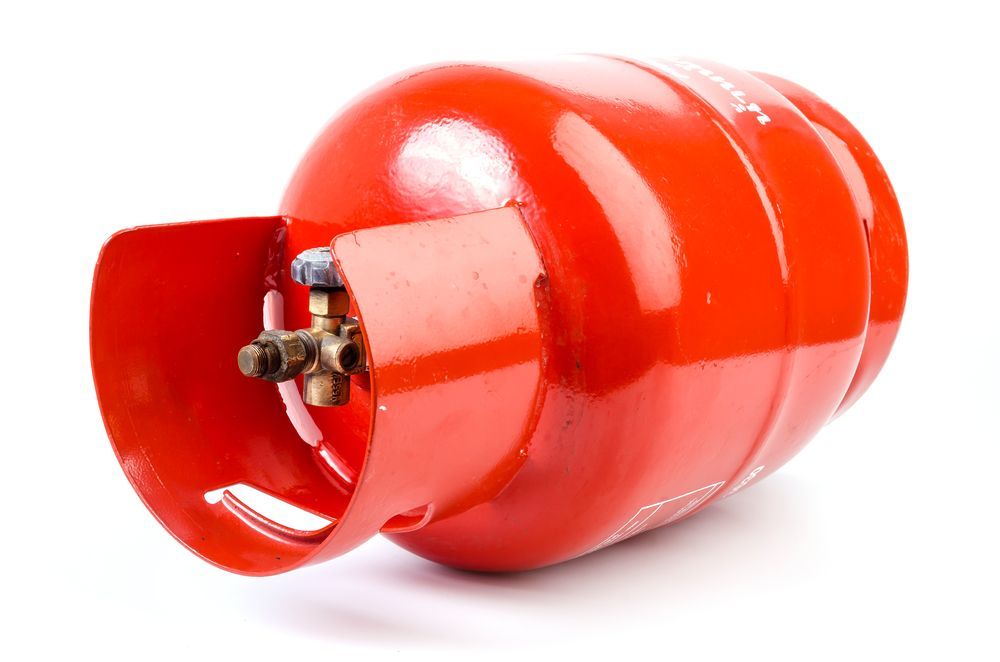Red propane gas cylinder with brass valve.